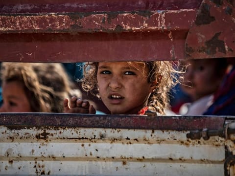 Syrian Arab and Kurdish civilians arrive to Tall Tamr town, in the Syrian northwestern Hasakeh province, after fleeing Turkish bombardment on the northeastern towns along the Turkish border on October 10, 2019.