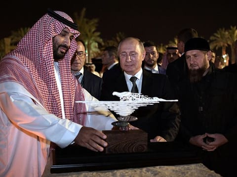 Russian President Vladimir Putin presents a gift made of mammoth tusk to Saudi Arabia's Crown Prince Mohammed bin Salman as head of the Chechen Republic Ramzan Kadyrov looks on in Riyadh, Saudi Arabia, October 14, 2019.