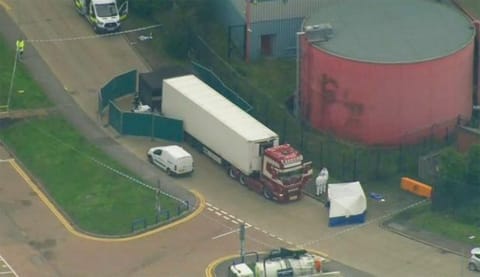 An aerial view as police forensic officers attend the scene after a truck was found to contain a large number of dead bodies, in Thurock, South England, early Wednesday Oct. 23, 2019. Police in southeastern England said that 39 people were found dead Wednesday inside a truck container believed to have come from Bulgaria.