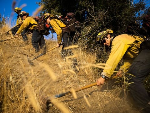 Firefighters with the Marin County Fire Department begin to dig a containment line ahead of the Kincade Fire, in the Geysers, a geothermal field in California on Friday, Oct. 25, 2019.