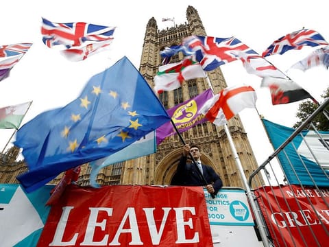 An anti-Brexit protester waves an EU flag outside the Houses of Parliament in London, Britain, October 25, 2019.