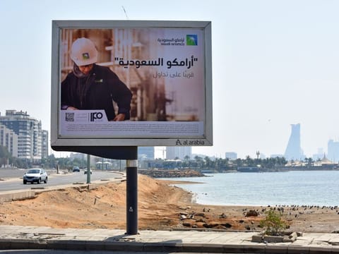 An advertisement of the planned Saudi Aramco initial public offering (IPO) sits on display at the Corniche coastline in Jeddah, Saudi Arabia