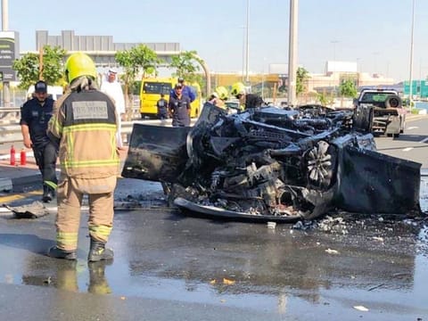 The mangled remains of the car and (inset) a video grab of the burning car. The accident happened at 12.49pm yesterday on Shaikh Zayed Road in the direction of Karama.