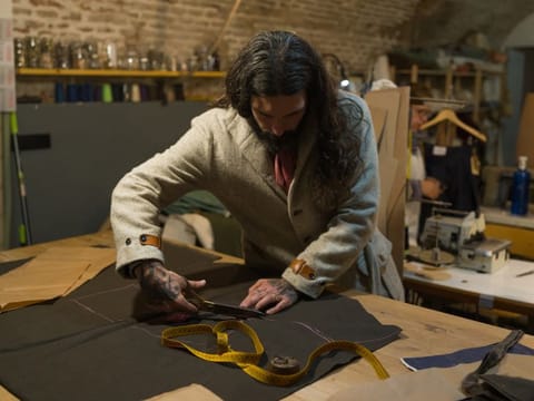 Fernando García de la Calera, who specializes in custom-made jeans, works at the Concrete in Madrid, Nov. 13, 2019. In the Spanish capital, shoppers looking for high-quality clothes and accessories can still find them — or have them made to order. (Samuel Aranda/The New York Times)