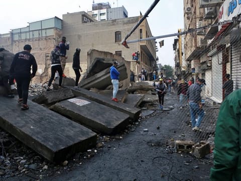 Protesters gather while security forces close River Street during ongoing anti-government protests in Baghdad, Iraq, Monday, Dec. 2, 2019.