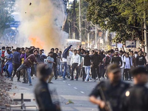 Protestors throw stones as they clash with the police during their march against the Citizenship (Amendment) Bill, 2019, in Guwahati, Wednesday, Dec. 11, 2019