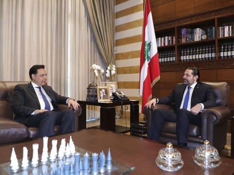 In this photo released by Lebanon's official government photographer Dalati Nohra, Lebanese Prime Minister-designate Hassan Diab, left, meets with outgoing Prime Minister Saad Hariri, in Beirut, Lebanon, Friday, Dec. 20, 2019.