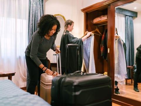 Girls just arriving in the hotel and unpacking clothes