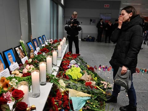 A woman reacts in front of a memorial for the victims of the Ukraine International Airlines Boeing 737-800 crash in the Iranian capital Tehran, at the Boryspil airport outside Kiev on January 8, 2020.
