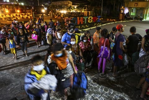 Residents are evacuated to a local school as the Taal volcano continues to erupt in Santo Tomas, Batangas, southern Philippines, Monday January 13, 2020. (AP Photo/Gerrard Carreon)