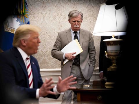 John Bolton, the then national security adviser, watches President Donald Trump in the Oval Office, at the White House in Washington on August 20, 2019.