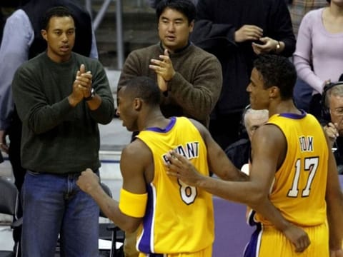 Tiger Woods cheers on Kobe Bryant during a LA Lakers game.