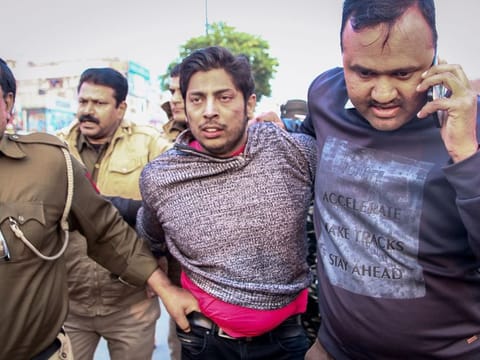 Shaheen Bagh shooter Kapil Gujjar being detained by police, in New Delhi on Saturday.