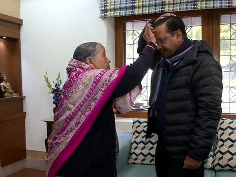 Chief Minister of Delhi Arvind Kejriwal, who is from AAP, takes the blessing of his mother before casting his vote, at his residence, in New Delhi on Saturday.