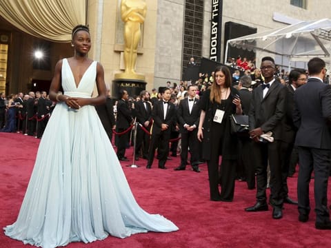 This March 2, 2014 file photo shows Lupita Nyong'o in a pale blue Prada dress at the Oscars in Los Angeles.