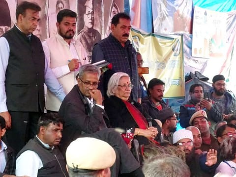 Senior Supreme Court lawyers Sadhana Ramachandran and Sanjay Hegde address demonstrators who have been protesting against CAA for over two months, at Shaheen Bagh, in New Delhi on Wednesday.