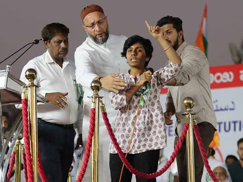 Indian lawmaker and President of the All India Majlis-e-Ittehadul Muslimeen (AIMIM) Asaduddin Owaisi, second left, prevents a student activist Amulya, second right, to continue talking after she raised pro-Pakistan slogans during a protest against a new citizenship law