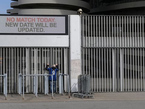 A man stands outside the San Siro stadium after the Inter Milan v Sampdoria Serie A match was cancelled due to an outbreak of the coronavirus in Lombardy and Veneto, in Milan, Italy, February 23, 2020.