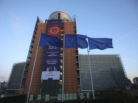 European Union flags flap in the wind outside EU headquarters in Brussels, Friday, February 21, 2020