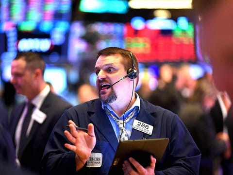 Traders work during the opening bell at the New York Stock Exchange (NYSE) on February 28, 2020 at Wall Street in New York City.