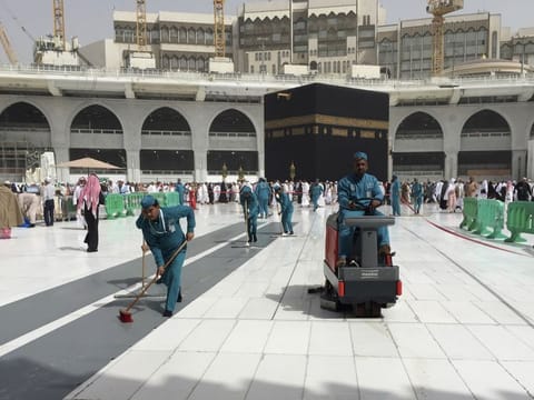 Workers clean the Grand Mosque, in Mecca