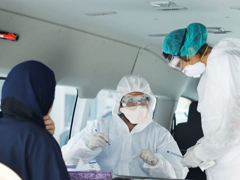 Doctors check a traveller in their designated residential area to check on residents who returned from Iran if anyone is infected with the novel coronavirus, at Eisa Town Health Centre, south of Manama, Bahrain on March 2.