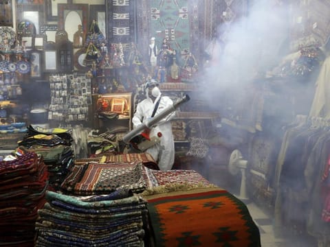 A firefighter disinfects a traditional shopping center to help prevent the spread of the new coronavirus in northern Tehran on March 6.