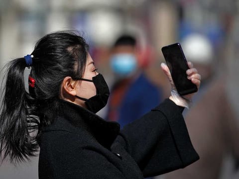 A masked woman at the Wangfujing shopping district in Beijing, China, on March 10, 2020.