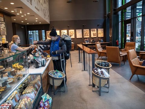 A Starbucks coffee shop sits mostly empty at Amazon headquarters on March 10, 2020 in downtown Seattle, Washington.