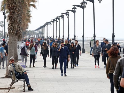 People walk along Beirut's seaside Corniche, Lebanon March 15, 2020.
