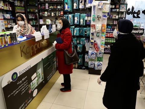 Customers wait as a pharmacist prepares medicines, in Tehran, Iran.US sanctions are squeezing Iran’s oil income, Iranians’ economic misery is palpable.