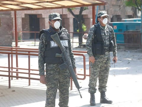 Pakistan Security personnel stand guard outside the Gaddafi Cricket Stadium in Lahore, Pakistan on Tuesday, March 17, 2020. The PSL has been postponed amid the coronavirus pandemic.