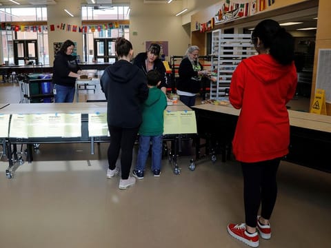 Children pick up lunch at the Olympic Hills Elementary School, after schools were closed due to the coronavirus disease (COVID-19) outbreak, in Seattle, Washington, US, March 17, 2020.