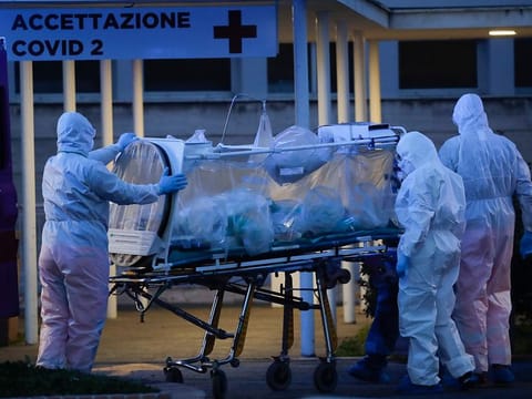 A patient in a biocontainment unit is carried on a stretcher at the Columbus Covid 2 Hospital in Rome.