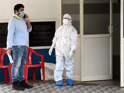 Illustrative purposes only: A man wearing a face mask speaks on his mobile phone outside the Special Isolation Ward of coronavirus patients at Aluva government general hospital in Kochi on Thursday.