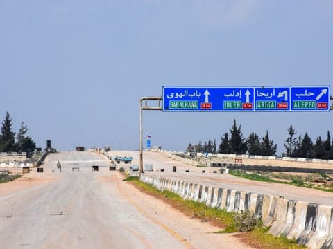 A Syrian army soldier stands guard on the M4 highway, which links the northern Syrian provinces of Aleppo and Latakia, on March 15, 2020. Russia and Turkey launched their first joint military patrol along the key M4 highway in Syria's Idlib region, following a ceasefire agreement earlier this month, Russian news agencies reported.