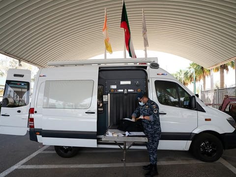 A Kuwait Ministry of Interior Special Forces officer checks a bag in Khairan, Kuwait.