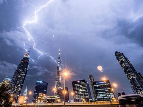 The magnificent Burj Khalifa stands tall amidst the lightning and thunder in Dubai skies