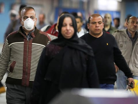 A man wearing a protective face mask walks at the underground Al Shohadaa metro station in Cairo. Both Egypt and Kuwait have already halted flights with the outside world as part of their precautions to contain the spread of the new coronavirus.