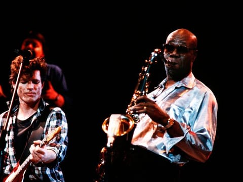 Cameroonian saxophone player Manu Dibango (R) and French guitarist Paul Personne perform in Bourges during the 8th Printemps de Bourges music Festival in 1986.