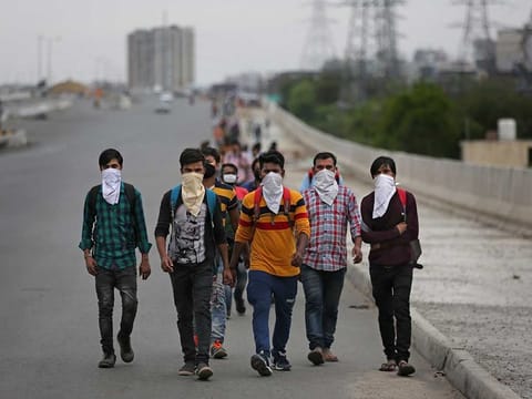File photo for illustrative purposes only: A group of Indian daily wage laborers walk along an expressway hoping to reach their homes, hundreds of kilometers away, as the city comes under lockdown in Ghaziabad, on the outskirts of New Delhi, India, Thursday, March 26, 2020.