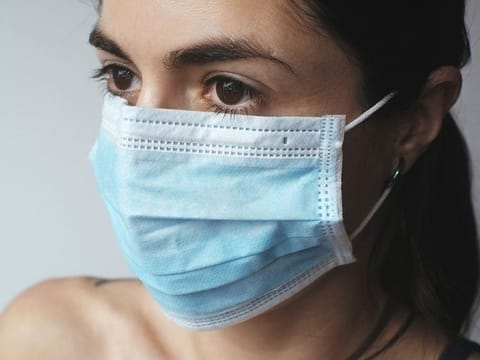 While a surgical mask may be effective in blocking splashes and large-particle droplets, a face mask, by design, does not filter or block very small particles in the air that may be transmitted by coughs, sneezes, or certain medical procedures
