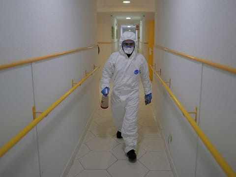 A member of the UME (Emergency Army Unit) wearing a protective suit to protect against coronavirus disinfects a nursing home in Madrid, Spain, on Tuesday, March 31, 2020.