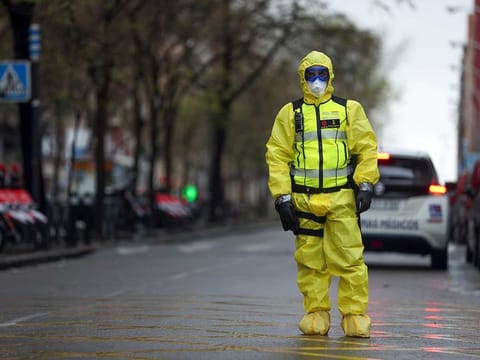 A member of the Emergency Military Unit waits for a bus in which patients infected with the COVID-19 are being transferred from the Gregorio Maranon hospital to a temporary hospital set up at the IFEMA conference centre, during the coronavirus disease (COVID-19) outbreak in Madrid, Spain April 1, 2020.