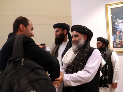 Members of Afghanistan's Taliban delegation gather ahead of an agreement signing between them and US officials in Doha in February 2020