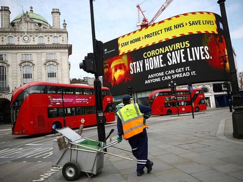 A UK government public health campaign is displayed in Piccadilly Circus, as the spread of the coronavirus disease (COVID-19) continues, London, Britain, April 8, 2020.