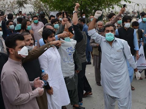 Doctors and paramedics shout slogans during a protest over the unavailability of safety equipment to handle coronavirus cases in Pakistan's southwestern city of Quetta on April 6, 2020.