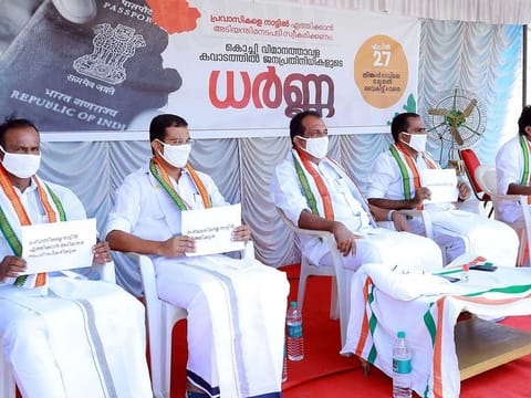 Parliamentarians and state legislators sit in protest seeking the return of stranded Indian nationals abroad, in front of Nedumbassery International Airport Kochi in Ernakulam on Monday.