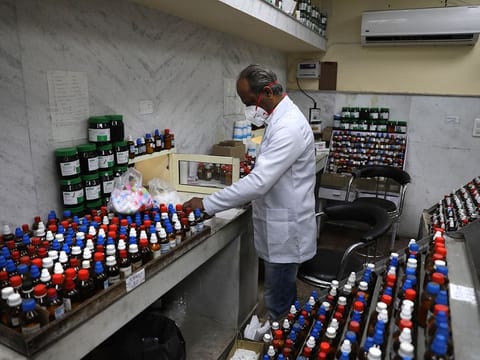 A doctor makes homeopathic pills in New Delhi, India.
