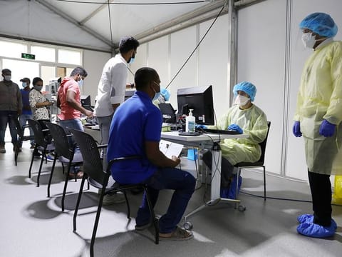 Medical staff wearing protective equipment intake patients to be tested at a clinich in UAE. REUTERS